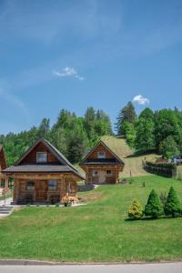 a log cabin with a hill in the background at Domek na Górkach in Krościenko