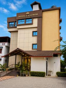 a hotel with a sign on the front of a building at Hotel La Gowri, Coorg in Madikeri