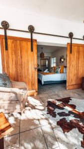 a bedroom with a bed and a couch in a room at Buff and Fellow by the Bay in Great Brak River +71 photos