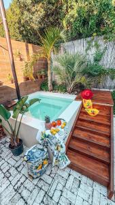 a small swimming pool with a wooden deck next to it at Buff and Fellow by the Bay in Great Brak River