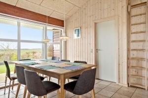 a dining room with a wooden table and chairs at LF626-Snedsted-Kongens-Borer-4 in Snedsted