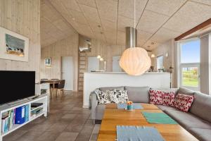 a living room with a couch and a tv at LF626-Snedsted-Kongens-Borer-4 in Snedsted