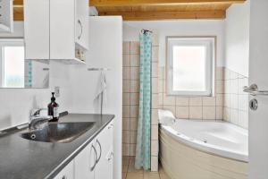 a bathroom with a sink and a bath tub at LF626-Snedsted-Kongens-Borer-4 in Snedsted +14 photos