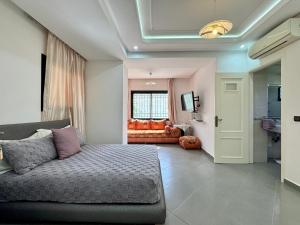 a living room with a couch and a window at Atlas View Luxury Villa in Ourika +81 photos