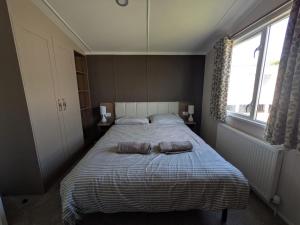 a bedroom with a bed with two pillows on it at Seaside Haven Hunstanton 2026 Model in Hunstanton