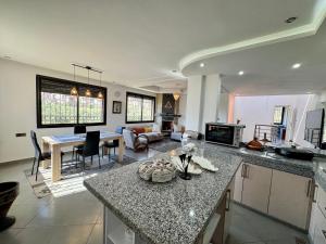 a kitchen and living room with a counter and a table at Atlas View Luxury Villa in Ourika