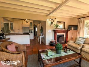 a living room with a couch and a table at Critchley Common in Dullstroom