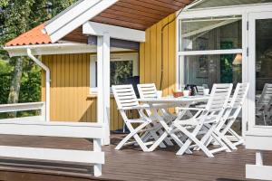 a table and chairs on a deck with a house at LF15147-Farso-Ramshule-47 in Farsø +13 photos