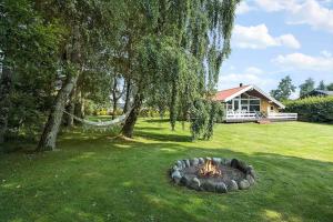 a fire pit in the yard of a house at LF15147-Farso-Ramshule-47 in Farsø