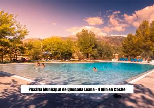 a pool at a resort with people in the water at Ruralux Sierra Quesada in Quesada