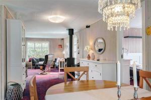 a living room with a dining table and a chandelier at LF16103-Farso-Kjeldhoj-103 in Farsø