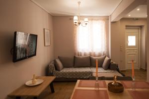 a living room with a couch and a table at Traditional House in Mytilene Center in Mytilene