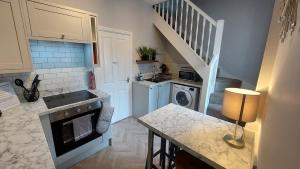 a kitchen with a sink and a stove at York city centre No7 Agar Street in York +12 photos