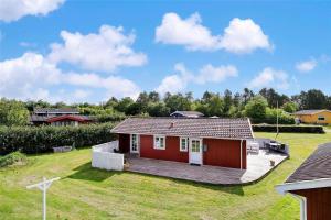 a small red house with a large yard at LF16103-Farso-Kjeldhoj-103 in Farsø