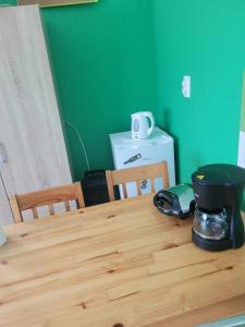 a kitchen table with a coffee maker on top of it at Căsuța de vacanță in Eforie Sud