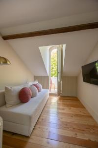 a living room with a couch and a window at Artsy Cascais in Cascais