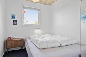 a white bedroom with a bed and a window at LF15194-Hojslev-Spaettevej-14 in Højslev