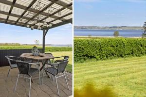 a patio with a table and chairs and a view of the water at LF15194-Hojslev-Spaettevej-14 in Højslev +14 photos