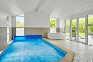 a large swimming pool in a bathroom with a tub at LF634-Vestervig-Gunhildsvej-54 in Vestervig