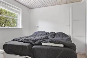 a bed in a white room with a window at 13328-Vig-Lillemosevej-5 in Vig +22 photos