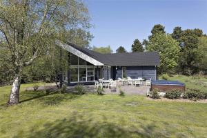a house with a patio and tables in front of it at 13328-Vig-Lillemosevej-5 in Vig