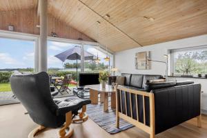 a living room with a couch and a table at LF320-Hurup-Thy-Skraningen-9 in Doverodde