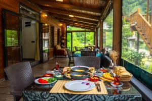 a dining table with food on it in a house at Pallas Suit in Ardeşen