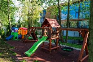 a playground with a green slide at Przystań Hotel&Restaurants in Olsztyn