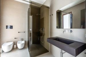 a bathroom with a sink and a shower at Aura - Stagnone Apartments in Marsala +43 photos