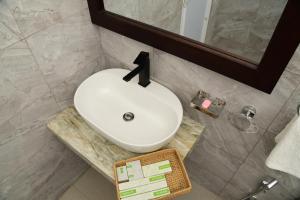 a bathroom with a white sink and a mirror at Ever Breeze Ella Hotel in Ella +151 photos