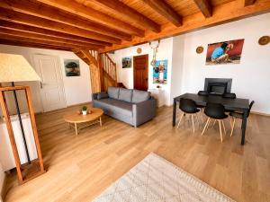 a living room with a table and a couch at Villa d'exception sur la plage - Tizzano in Sartène