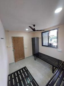an empty room with a bed and a window at UrBan PG&HOSTEL Deluxe Triple Accommodation Boy's Only in Pune