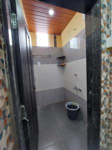 a bathroom with a shower with a bucket in it at UrBan PG&HOSTEL Deluxe Triple Accommodation Boy's Only in Pune