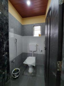 a bathroom with a toilet and a shower at UrBan PG&HOSTEL Deluxe Triple Accommodation Boy's Only in Pune