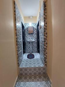a bathroom with a sink and a tile floor at UrBan PG&HOSTEL Deluxe Triple Accommodation Boy's Only in Pune