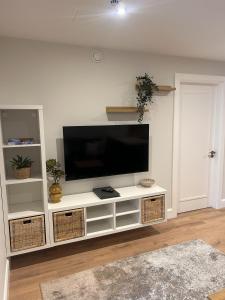 a white entertainment center with a flat screen tv at Village Centre Haven in Clifden