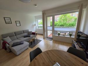 a living room with a couch and a table at FeWo Büsum No 12 in Büsum