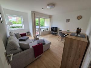 a living room with a couch and a table at FeWo Büsum No 12 in Büsum