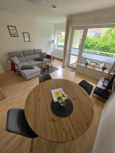 a living room with a wooden table and chairs at FeWo Büsum No 12 in Büsum