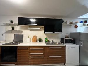 a kitchen with a sink and a stove top oven at Yasmin Breeze Apartment in Nerezine