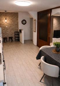 a living room with a table and chairs and a kitchen at Yasmin Breeze Apartment in Nerezine +54 photos