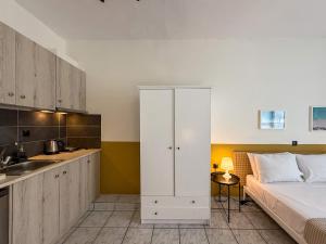 a bedroom with a bed and a kitchen at Seagull apartments - A in Paralia Katerinis +34 photos