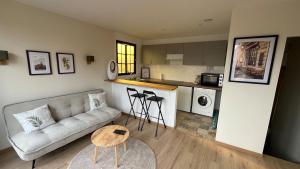 a living room with a couch and a table at Duplex Signature - Downtown - Sens in Sens