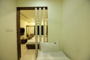 a room with a bed and a mirror at Hotel Sigma Suites in Bangalore +85 photos