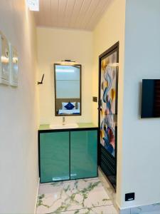 a room with a large mirror and a sink at Breeza Residency in Kazhakuttam