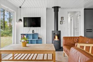 a living room with a couch and a fireplace at LF15197-Hojslev-Venovej-36 in Højslev