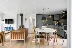 a kitchen and dining room with a table and chairs at LF15197-Hojslev-Venovej-36 in Højslev