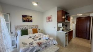 a small bedroom with a bed and a kitchen at Estudios Costavigía Mazagón by Ramona in Mazagón +119 photos