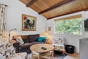 a living room with a couch and a table at 10054-Rorvig-Lindegardsvaenget-27 in Rørvig