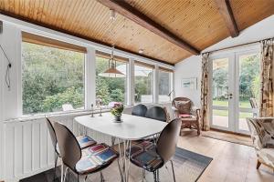 a dining room with a white table and chairs at 10054-Rorvig-Lindegardsvaenget-27 in Rørvig